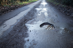 Council road repairs cash down £400m next year image